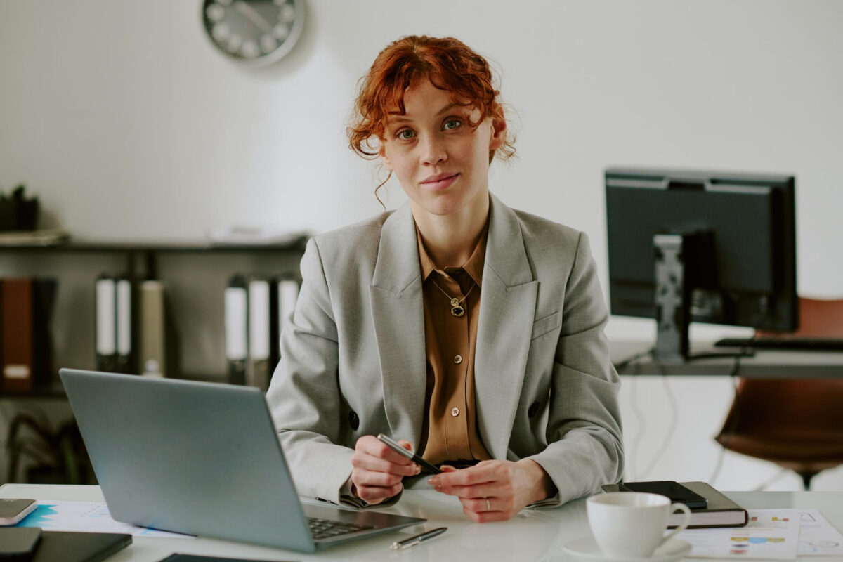 Professional team leader sitting at a desk with a laptop