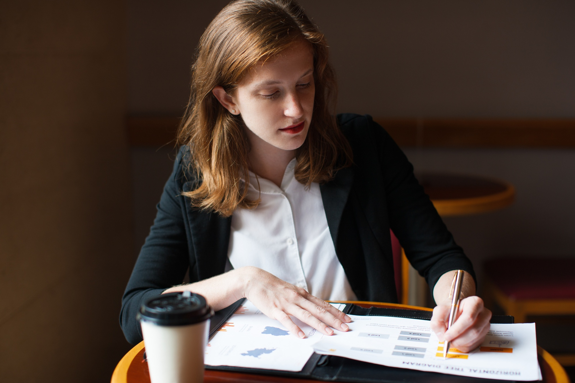 Serious businesswoman working with papers about finance