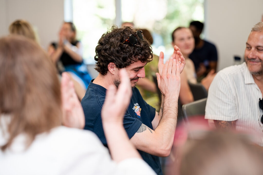 Learners high-fiving each other during a Learnmore training session